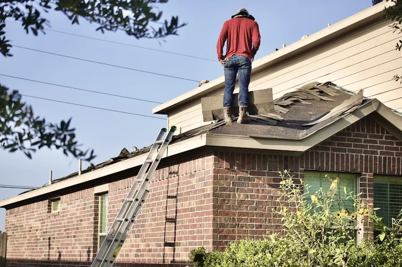 Professional roofer working on a residential roof in Grand View North